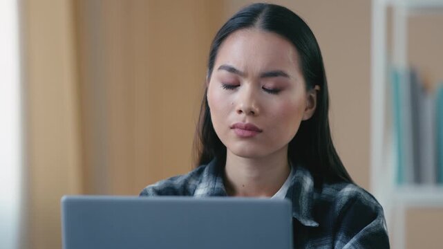 Frustrated stressed Asian Korean business woman looking laptop reading bad news at home desperate female girl disappointed businesswoman computer error mistake loss unsaved document debt bank message