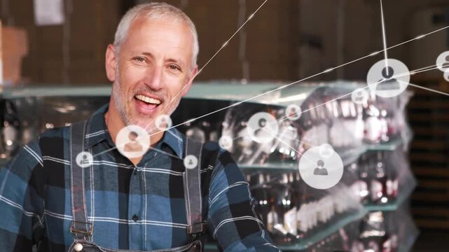 Worker placing box on pallet jack in warehouse, network nodes linking, giving thumbs-up for stock