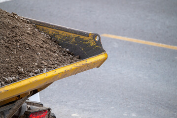 Yellow Dumper Truck with Gravel The Concept of Industrial Transport. © VicVaz