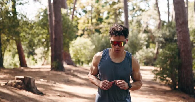 Smart watch, fitness and man in woods, running performance and digital app to track progress. Energy, runner and person in forest, exercise and cardio workout with challenge, monitor time or results