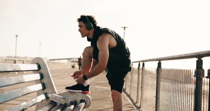 Outdoor, shoelace and man with fitness, rest and comfort with footwear, exercise and shoes. Pause, person or athlete with sneakers for performance, workout or training for wellness or break in Canada