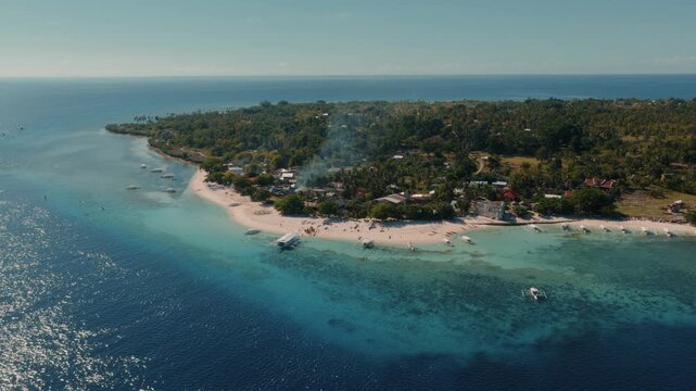 High aerial view of tropical island coastline with white sand beach and coral reef waters Panglao Bohol Philippines, drone