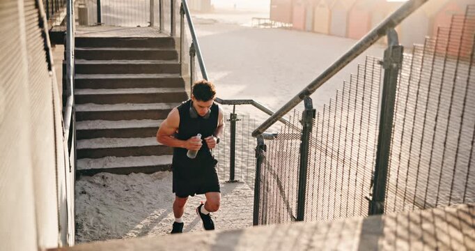 Fitness, man or running on stairs at beach for HIIT workout, endurance challenge or burning calories. Water, athlete or training on steps outdoor for athletic performance, exercise routine or stamina