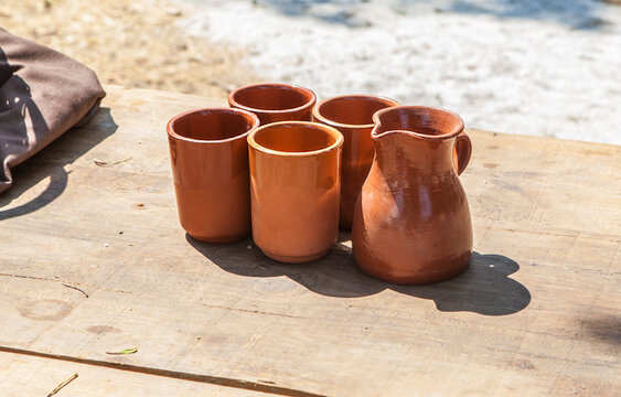 Clay glasses over wooden table