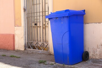 Naklejka premium Waste sorting for recycling - garbage bin colors in Italy. Domestic waste bin. Blue bin for paper and cardboard.