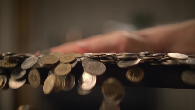 hand holding coin savings in slow motion. Money cash coins concept background
