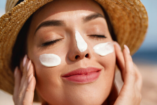 Beauty, suntan spf and skincare cosmetics model face portrait, woman with moisturizing cream. Girl using sunscreen to skin. 