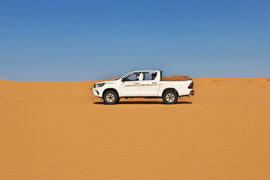 Chinguetti, Mauritania - 11 Jan 2022: Cars on sand dunes of Sahara Desert , Mauritania, West Africa