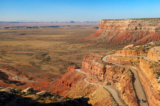 Steep switchbacks of unpaved scenic Moki Dugway ascending 1,200 feet along the edge of Cedar Mesa, offering stunning views of the Valley of the Gods, Utah, Southwest USA