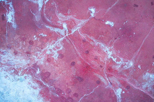 Aerial view of a surreal landscape, where crimson waters meet delicate white patterns, creating an otherworldly mosaic of color and texture, Salt Lake City, Utah, United States.