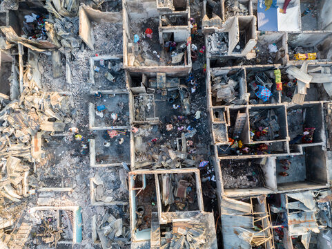 Aerial view of the stark remnants of buildings, with people amid the debris, contrasting destruction with resilience, Dhaka, Dhaka Division, Bangladesh.