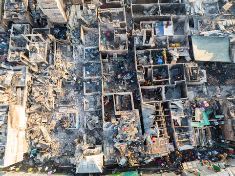 Aerial view of a desolate landscape with charred structures and debris where homes once stood, a somber tableau of loss and destruction, Dhaka, Dhaka Division, Bangladesh.