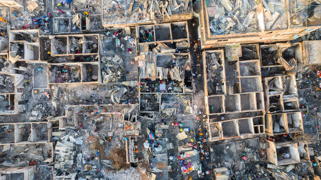 Aerial view of the stark ruins and debris-strewn landscape where structures once stood tall, now a mosaic of gray and white amid the bustling activity, Dhaka, Dhaka Division, Bangladesh.