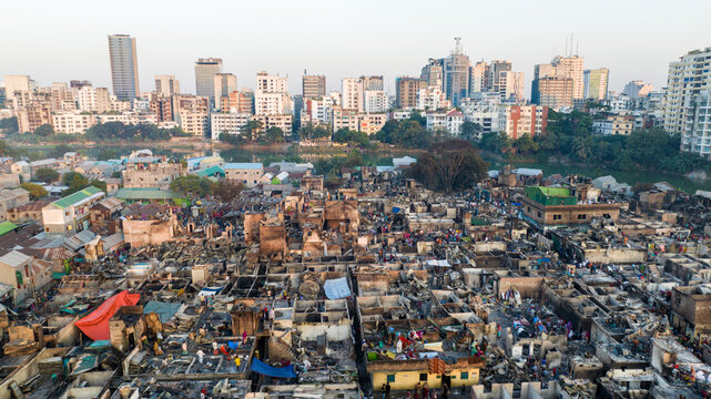 Aerial view of destroyed buildings contrasting with the modern skyline in the distance, a scene of devastation, Dhaka, Dhaka Division, Bangladesh.