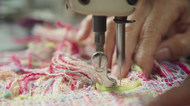 Sewing machine stitching colorful fabric close up tailoring production process