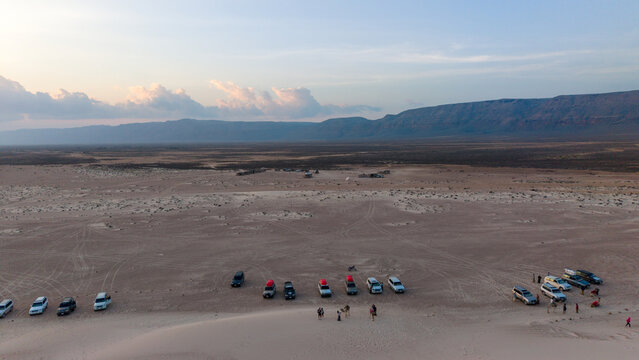 Aerial desert meetup with off-road vehicles at dusk. Zahek Sand Dunes, Sokotra Yemen.