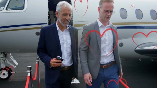 Animation of heart icons over caucasian business people talking
