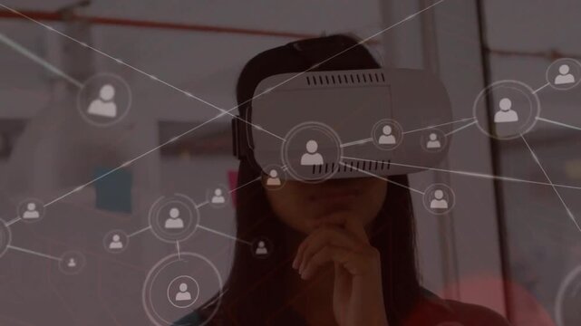 Animation of connected icons over thoughtful caucasian woman using vr headset
