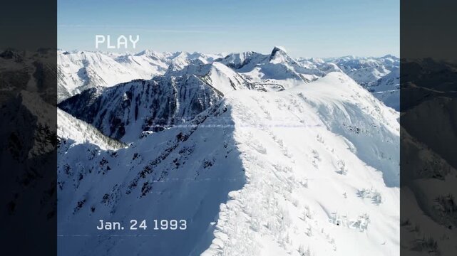 VHS PLAY label, date stamp initiating viewpoint drifting along snowy ridge revealing distant peaks