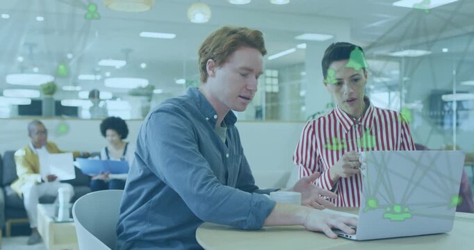 Red-haired male typing showing IT network icons while female colleague pointing nodes collaborating
