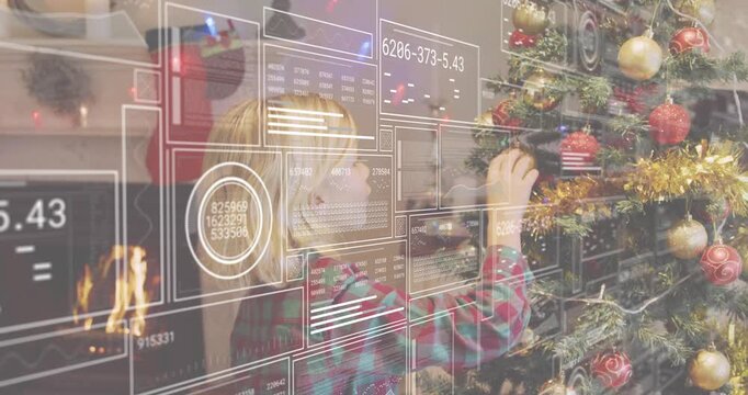 reaching up to pick bauble, boy in plaid decorating tree using baubles, tinsel for holiday decor