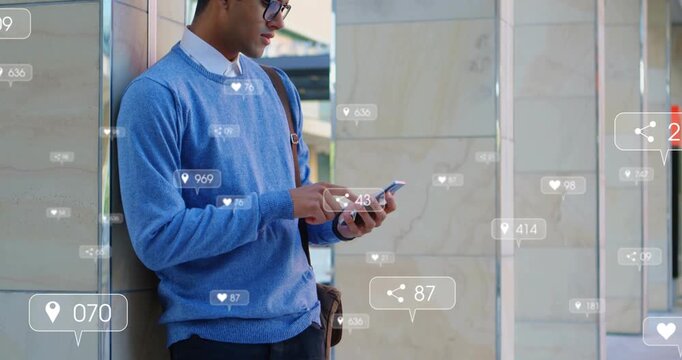 Adult male leaning on column, tapping phone and checking social metrics as likes and pins floating