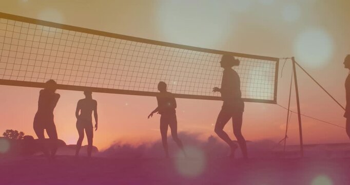 Vertical video: Women playing volleyball reacting to ball jumping and blocking at net keeping rally