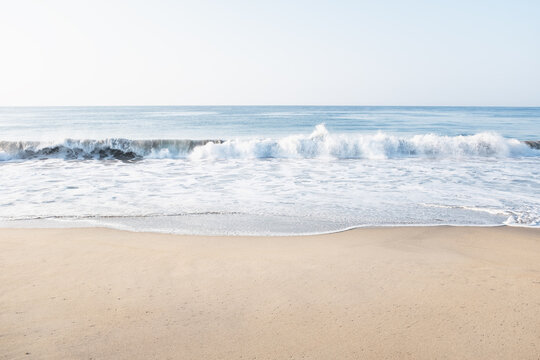 Ocean waves washing empty beach