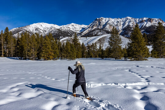 Woman snowshoeing on sunny winter day