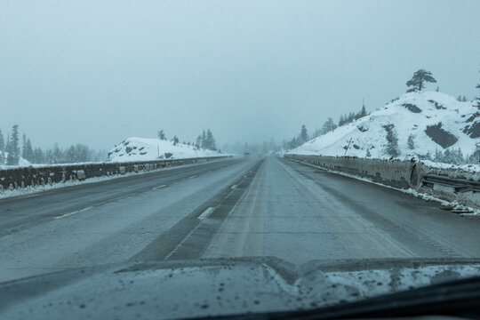 Empty highway seen from car during rain in winter