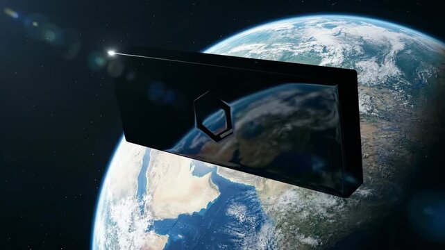 Dark rectangular module with emblem floating in Earth orbit. Futuristic communication device rotating against planet background