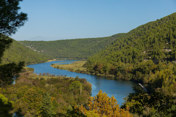 Fototapeta premium River winding through green hills aerial landscape