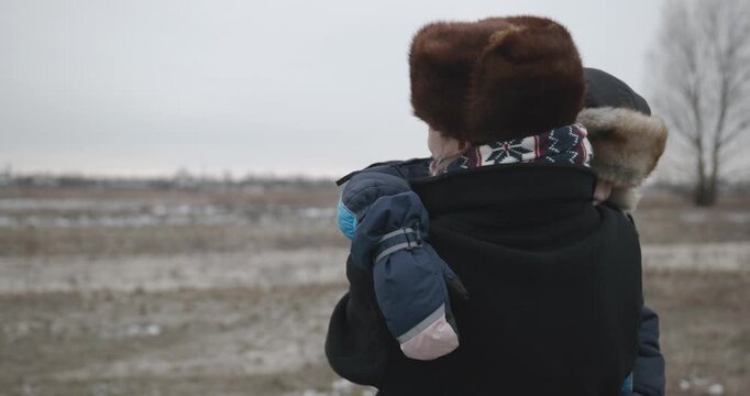 Man and kid boy go for walk. Dad and son play outside. 4K 10-bit