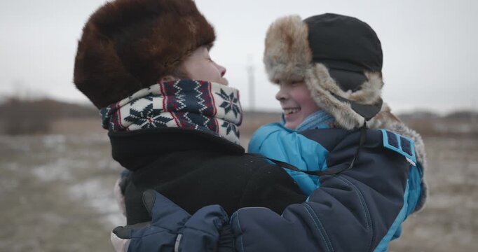 Man and kid boy go for walk. Dad and son play outside. 4K 10-bit