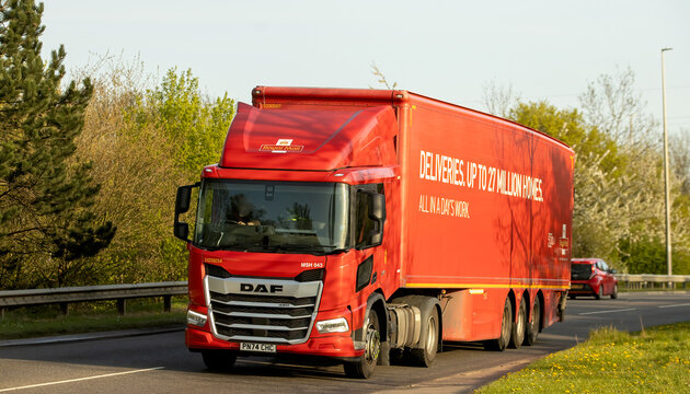 Milton Keynes,Bucks,UK - Apr 8th  2026:  2024 red DAF XD 450 FT Royal Mail delivery truck  driving. on a British road
