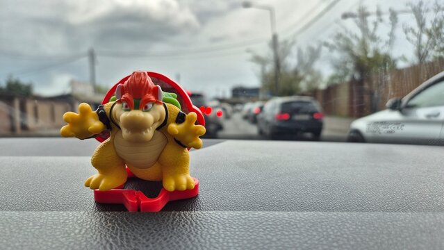 MCdonalds Happy Meal Toy ( Super Mario Character ) on the board of the car taken on April 9, 2026 in Bucharest, Romania.