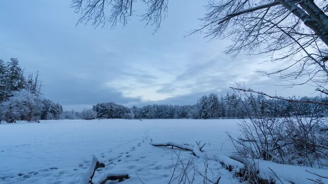 Wonderful winter timelapse in Massachusetts, with a frozen lake right after a snowfall, snow on the trees, Harold Parker State Forest in Andover