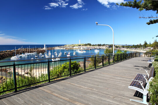 Idyllic, scenic view from a timber boardwalk lookout to the Illawarras famous dual lighthouses located on Flagstaff Hill and the Wollongong Harbour Breakwater, Belmore Basin, NSW Australia.