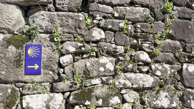 Camino de Santiago Shell Waymark on Rustic Stone Wall in Spain