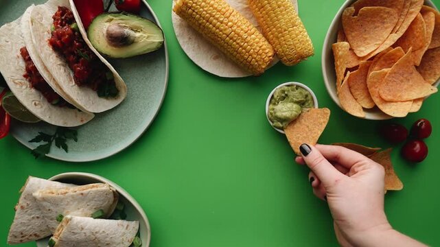 A gourmet healthy meal featuring fresh vegetables on the grill and a red plate atop a white table with sliced bread and cheese for a fresh dinner with nobody