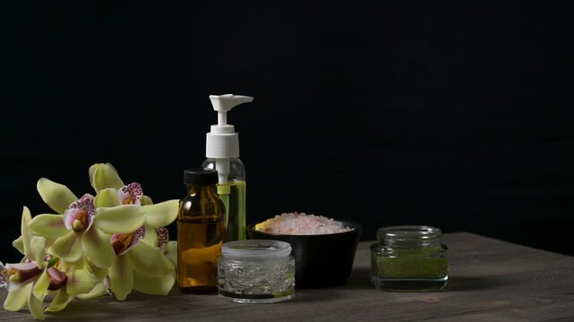 Arrangement of spa and beauty products on black background
