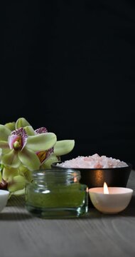 Arrangement of spa and beauty products on black background