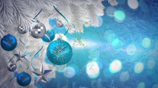 Animation of decorated christmas tree branch over spots of light against blue background