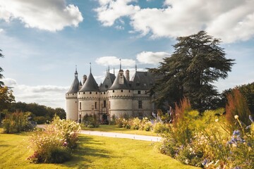 Strolling through the vibrant gardens, the stunning architecture of the castle captivates under the warm sun