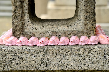 日本の神社に並ぶ可愛いピンクのうさぎと伝統的な石灯籠 © taka