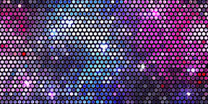 Abstract background of shimmering colorful round sequins in a dense pattern