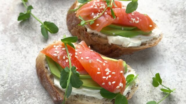Healthy salmon avocado bruschetta appetizer rotating