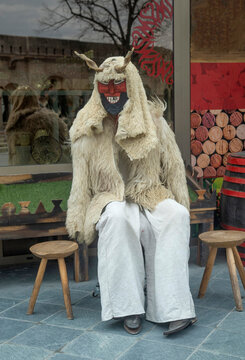 Traditional Hungarian Buso figure with carved wooden mask and sheepskin coat from Busojaras carnival in Budapest, Hungary