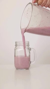 Fresh Strawberry and Blueberry Juice Pouring Into Clear Glass Cup &ndash; Healthy Berry Drink Close Up, Refreshing Fruit Beverage