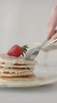 Cutting Strawberry Pancake With Spoon &ndash; Fluffy Pancake With Fresh Strawberry Topping Close Up Breakfast Dessert